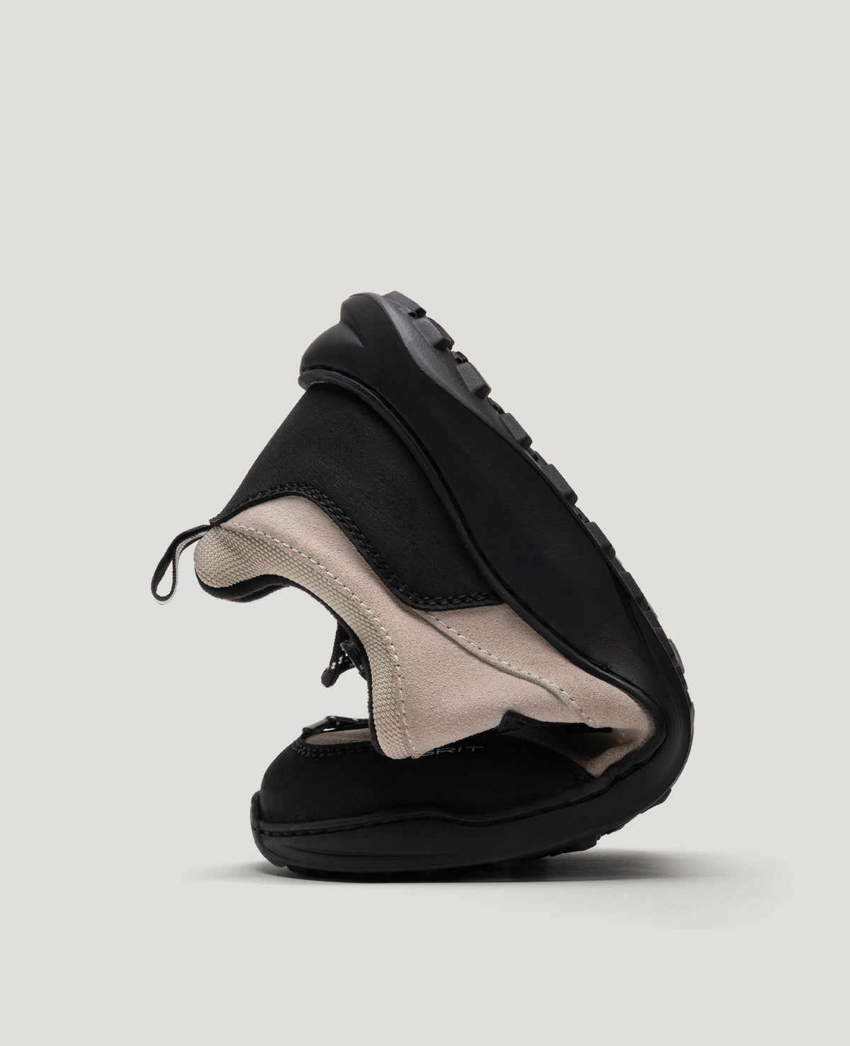 ZERO GRIT Ecru barefoot sneaker folded in half to show its flexible sole