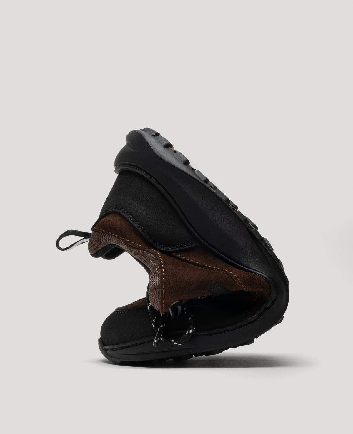 ZERO GRIT Rich Brown barefoot sneaker folded in half to show its flexible sole